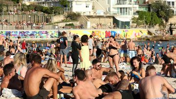 Beachgoers are seen at Bondi Beach despite the threat of Coronavirus (COVID-19) in Sydney, Friday, March 20, 2020.