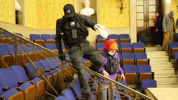 A protester spotted inside the Senate chamber carrying plastic zip-tie handcuffs has prompted theories some in the Capitol riot wanted to catch and detain hostages.