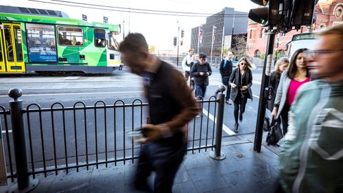 Commuters alight trams outside South Yarra station, in Melbourne.