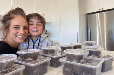 Nine-year-old Ariel Sher and his Mum, Vanessa in their kitchen with his baked goods.