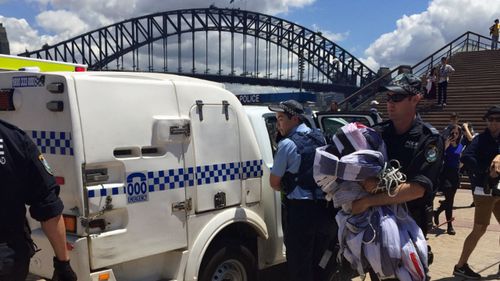 Police pulled an abseiling climber from the west-facing sail only moments before a 60m banner was unfurled. (9NEWS)