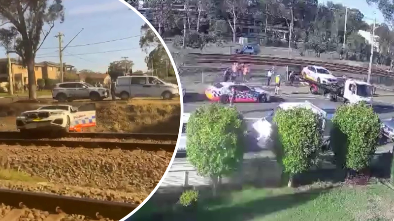 Lucky escape for police after car lands on train tracks | Nine.com.au