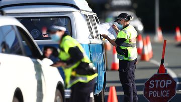 Queensland Police stop vehicles on the Queensland-NSW border in Coolangatta, 