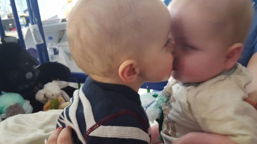 Baby twins reunited after 14 months apart as one underwent heart transplant