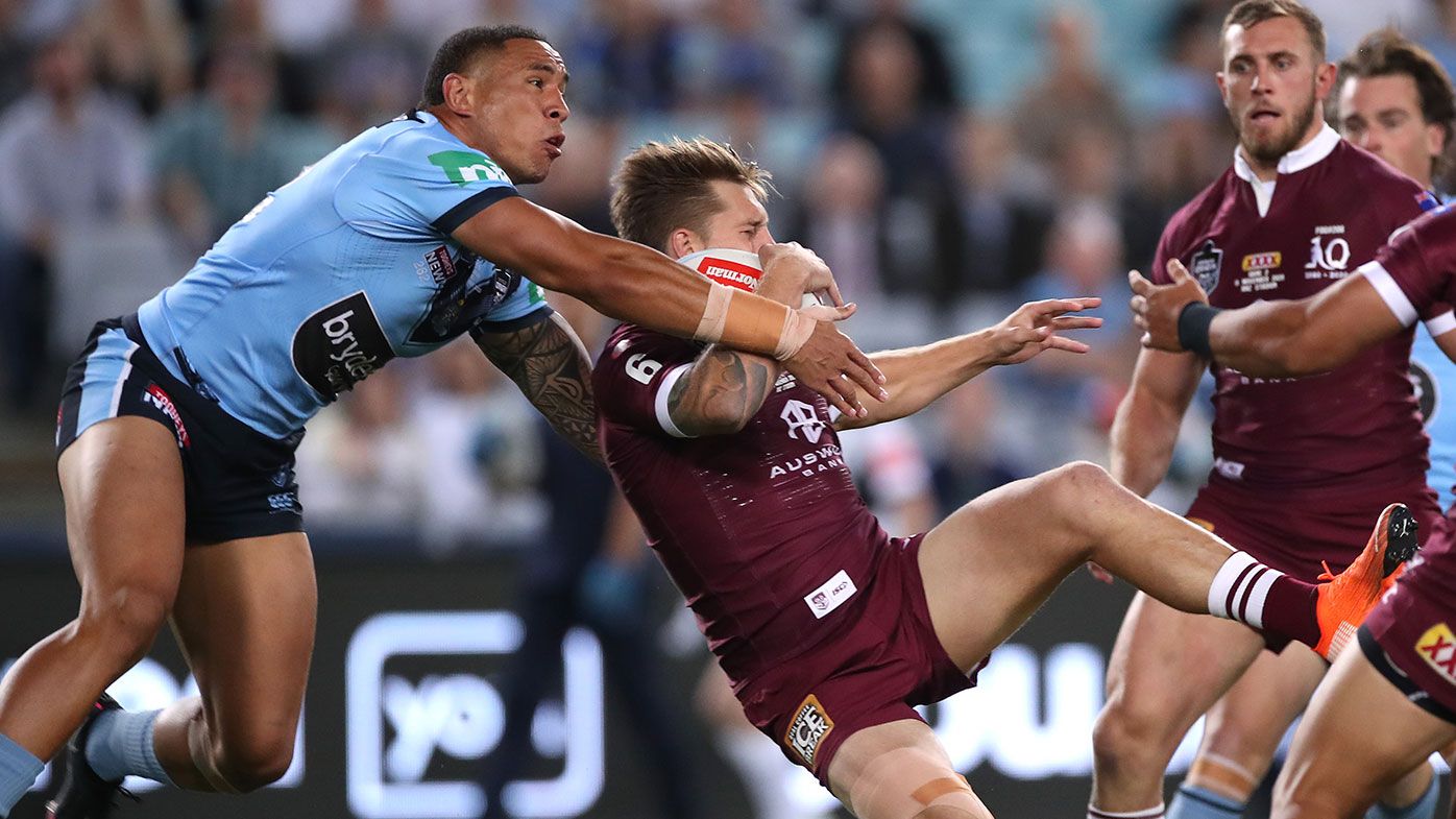 Cameron Munster of the Maroons and Tyson Frizell of the Blues compete for the ball during game two of the 2020 State of Origin series