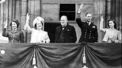 In this May 8, 1945 file photo Britain's Prime Minister Winston Churchill, center, joins the Royal family, from left, Princess Elizabeth, Queen Elizabeth, King George VI, and Princess Margaret, on the balcony of Buckingham Palace, London, England, on VE-Day. 