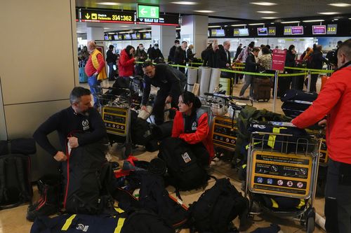 Spanish firefighters with their equipment at Barajas international airport, in Madrid, Spain, Monday, Feb. 6, 2023, before boarding a flight to help with a rescue mission in Turkey.  