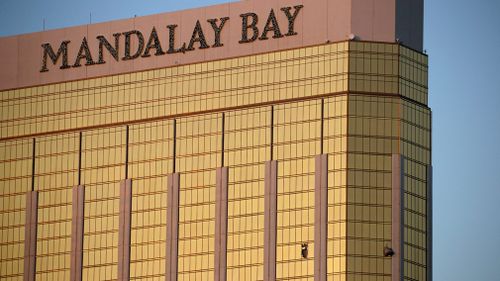 Drapes billow out of broken windows at the Mandalay Bay resort and casino  (Image: AP/John Locher)