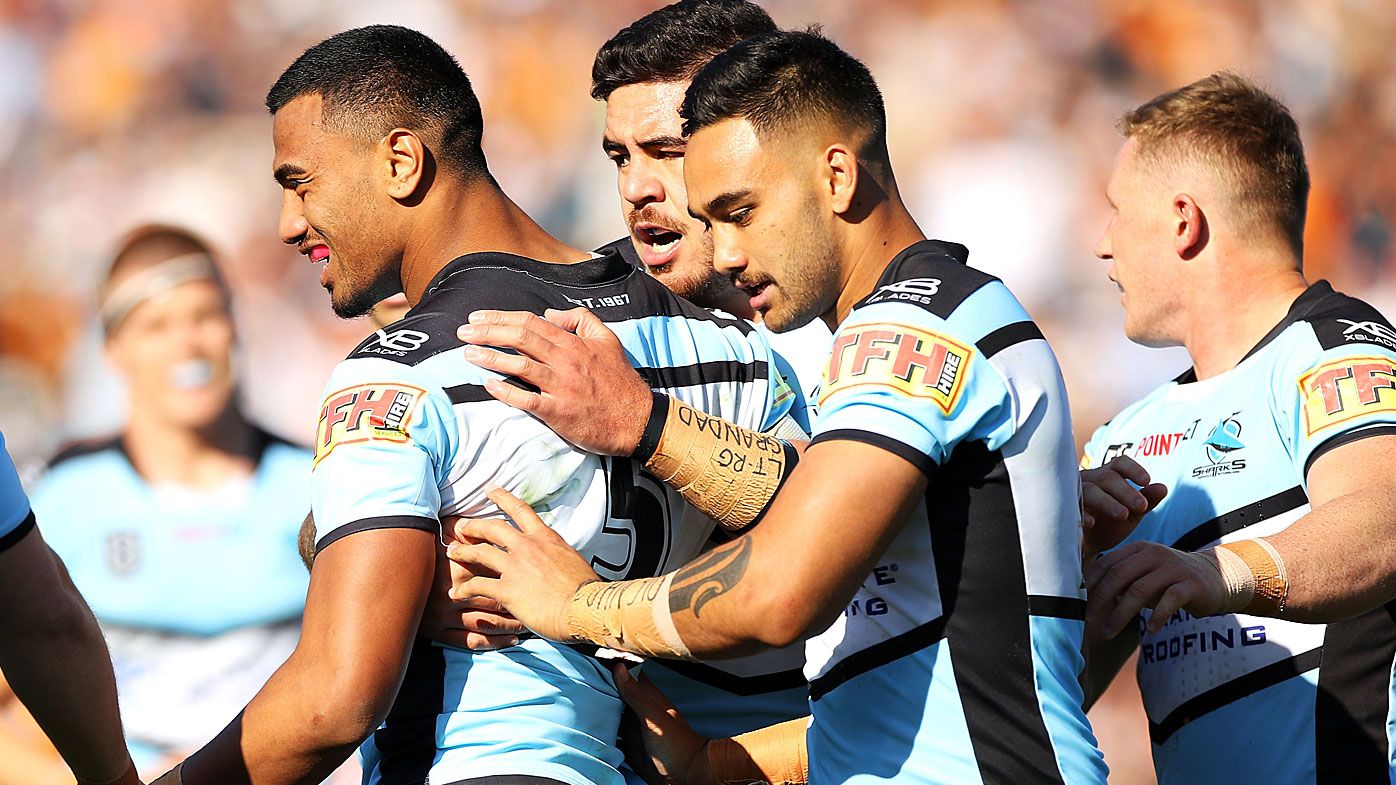 Ronaldo Mulitalo of the Sharks celebrates with his team after a tackle 