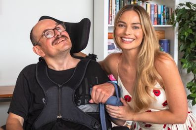 Margot Robbie smiles during her visit with Brian (left).