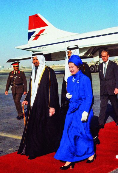 Queen Elizabeth II is greeted by King Khalid when she arrives in Saudi Arabia, wearing a long dress to respect the Saudi Arabian customs during her visit to Saudi Arabia in February of 1979. (Photo by Anwar Hussein/Getty Images)