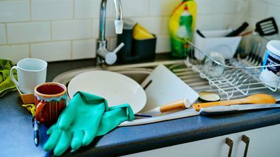 A kitchen sink full of dirty dishes