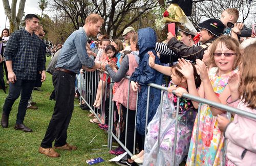 Harry decided he couldn't get much wetter and shook yet more hands as his shirt slowly became drenched.