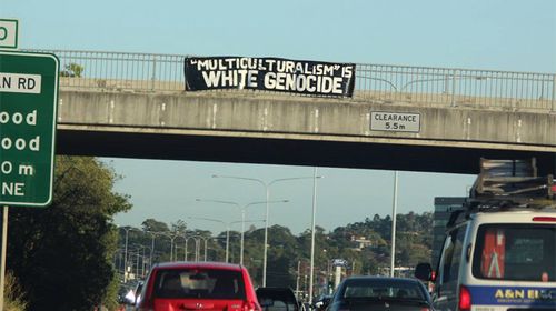 Council investigates after anti-multiculturalism banner hung over Queensland highway