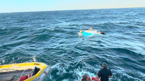 Heavy swell threw the four men out of their 5.7 aluminium cruiser into the ocean.