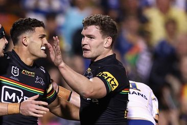 Dylan Edwards of the Panthers celebrates scoring a try with Nathan Cleary and Liam Martin of the Panthers during the round two NRL match between Penrith Panthers and Parramatta Eels at BlueBet Stadium, on March 15, 2024, in Penrith, Australia. (Photo by Jason McCawley/Getty Images)