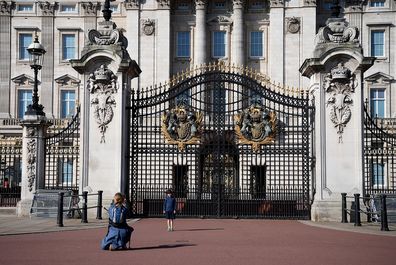 A young boys poses for a photo outside Buckingham Palace on April 26, 2020.