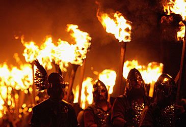 On which archipelago does the Up Helly Aa torchlit procession take place?