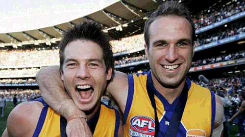 Cousins (left) celebrates the 2006 premiership with Chris Judd. (AAP)