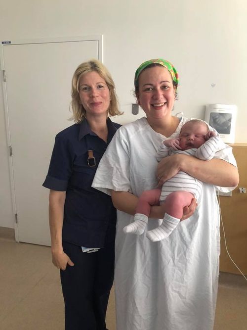 Midwife Alex, Dr Martin, with baby Parker in Blacktown Hospital. 