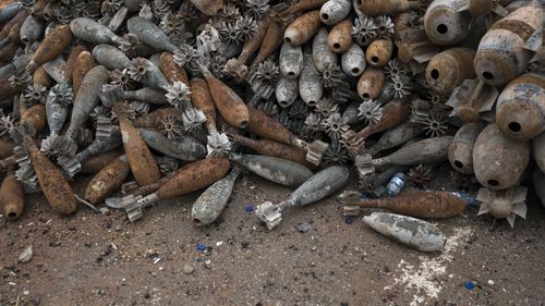 Unexploded mortar shells are gathered on a street in the main hospital complex area in Mosul, Iraq. (AAP) 