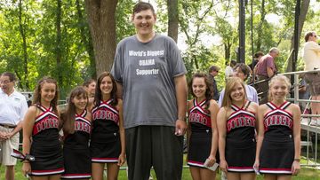 Igor Vovkovinskiy towers above a group of cheerleaders from the Cannon Falls High School in Cannon Falls, Minnesota.