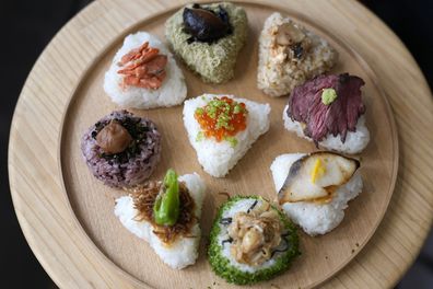 A variety of onigiri, rice balls, are seen on a plate at a Taro Tokyo Onigiri shop in Tokyo, on June 5, 2024