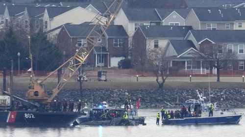 The air traffic control tower at Ronald Reagan Washington National Airport is pictured, Friday, Jan. 31, 2025, in Arlington, Va., near the wreckage of a mid-air collision between a Black Hawk helicopter and an American Airlines jet in the Potomac River. (AP Photo/Alex Brandon)