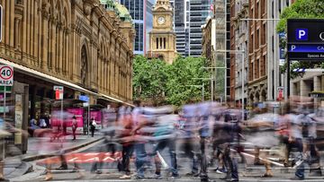 People crowd crossing street in central Sydney