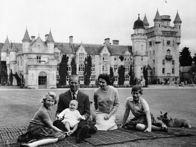 In this 1960 photo, Queen Elizabeth, Prince Philip and their children, Prince Charles,  Princess Anne and Prince Andrew sit on the lawn of Balmoral Castle