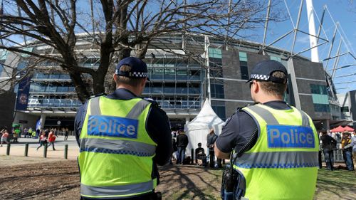 Two police officers stand outside the MCG. (AAP)