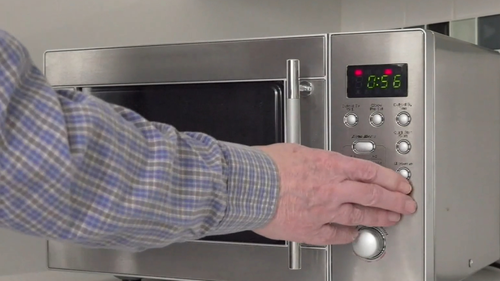 Person using microwave