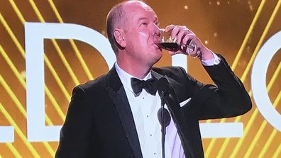 Tom Gleeson drinks wine while delivering his Gold Logie acceptance speech