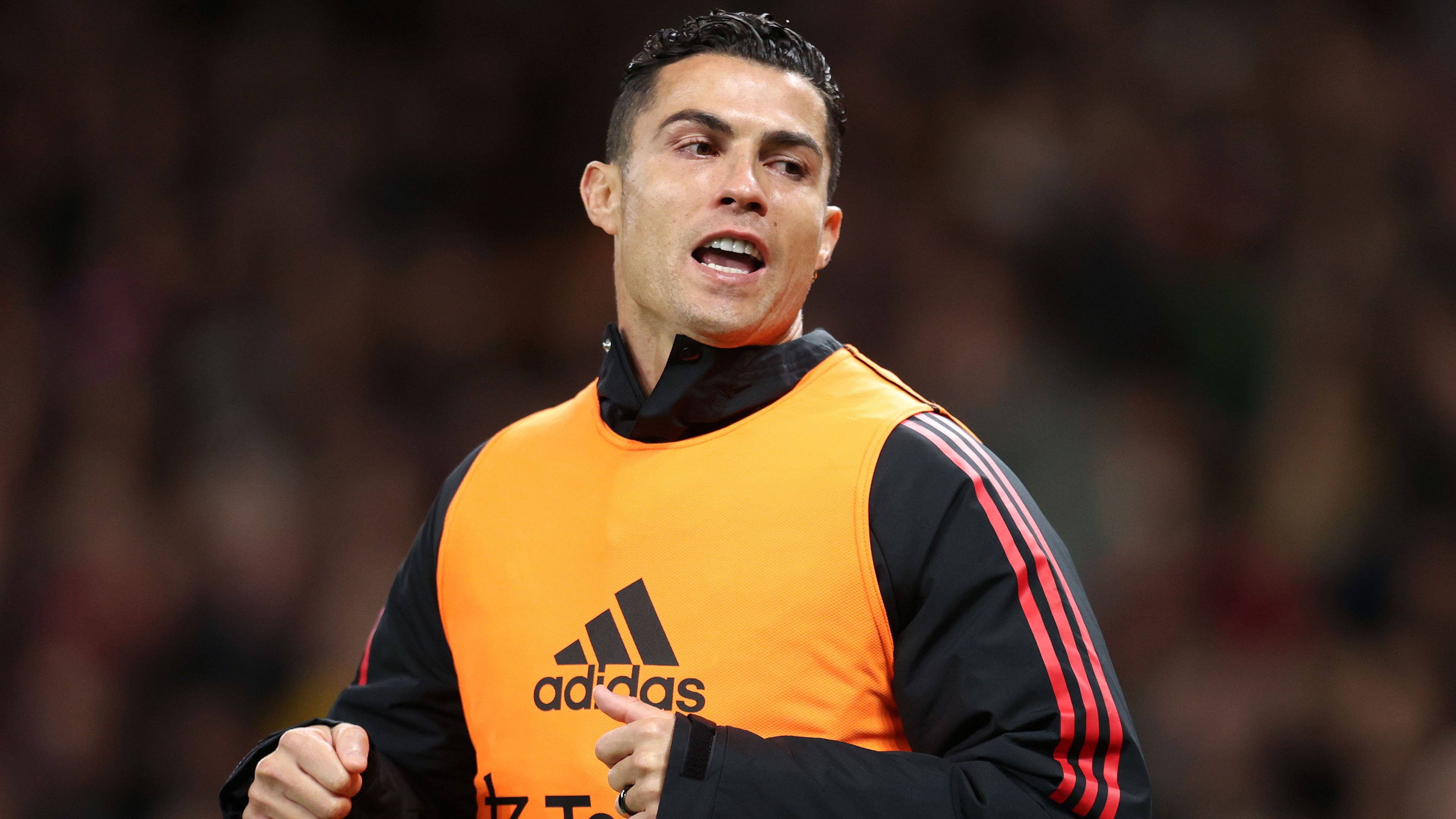 Cristiano Ronaldo warms up on the sidelines but was an unused substitute for Manchester United against Tottenham.