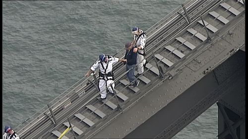 Police negotiators escorted the man from the southern arch of the Sydney Harbour Bridge. (9NEWS)