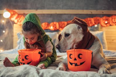 Little girl with pet dog Halloween
