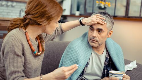 Couple cold flu sick man woman looking after partner influenza temperature man flu