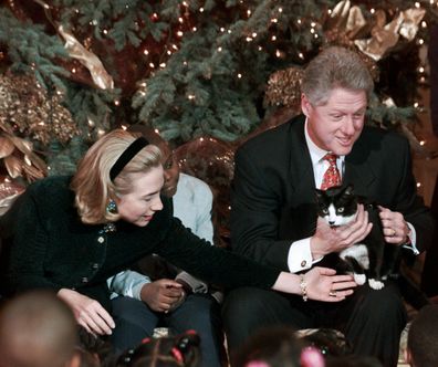 President Clinton holds Socks the cat as he and first lady Hillary Clinton host Washington area elementary school children at the White House in 1996