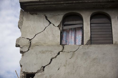 Cracks are seen in the facade of a home damaged by a magnitude 5.9 earthquake the night before, in Gros Morne, Haiti