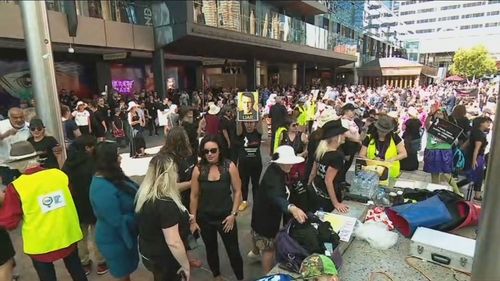 Women took the stage to share their stories, before marching side-by-side in a crowd. 