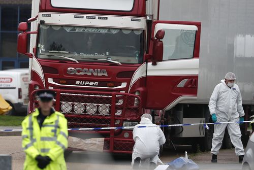 Forensic police officers attend the scene after a truck was found to contain a large number of dead bodies, in Grays, England, October 23, 2019.  