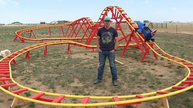Dad builds rollercoaster for son in backyard. 