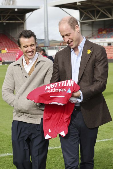 Prince William, Prince of Wales talks with Chairman of Wrexham AFC Rob McElhenney, left, on the pitch at the Racecourse Ground, the home of Wrexham AFC in Wrexham, Wales, Friday March 1, 2024, to mark St. David's Day. 