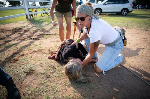 Police allege the woman has suffered suspected spinal injuries after a man allegedly knocked her over during a horseback anti-Adani protest in central Queensland.