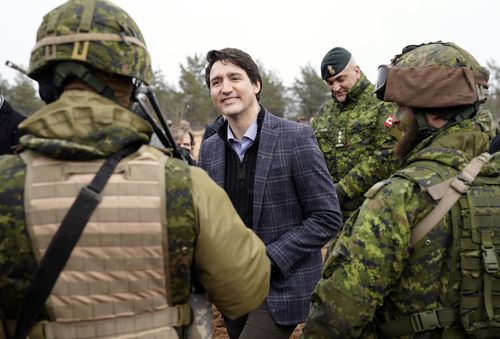 Canadian Prime Minister Justin Trudeau smiles while speaking to Canadian troops during his visit to Adazi Military base in Kadaga, Latvia, on March. 8, 2022 