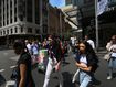 Pedestrians move across Market Street in Sydney, Australia. 