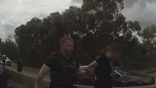 A father and his son are seen being arrested on the wrong side of Roe Highway, after crashing into a truck, in footage released by WA Police on Saturday.