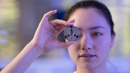 PHD scholar Xingshuo Huang from the Australian National University holds the diamond anvil that the team used to make the lab diamonds.