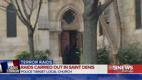 Police officers smash their way into the Denis de l'Estree church, near the site of the siege. (9NEWS)