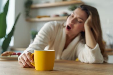 woman yawning morning coffee tired